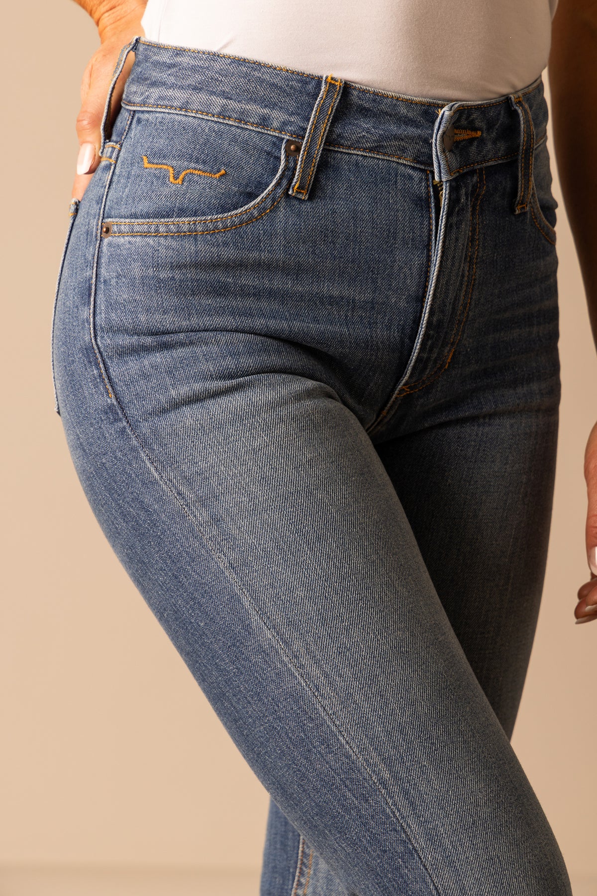Kimes Ranch Jennifer Dark Wash mid wash jeans with back pocket stitching and orange contrast stitching