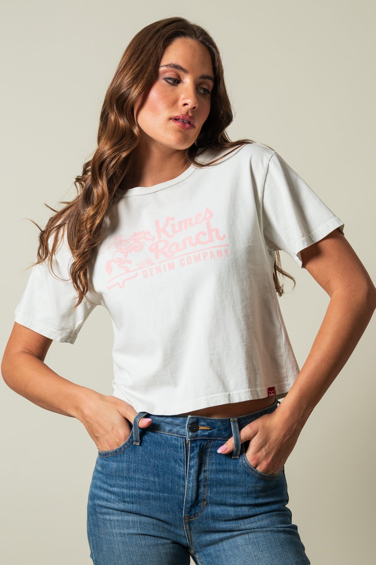 Kimes Ranch Davona Dale Natural short-sleeve crewneck crop top featuring pink Kimes Ranch Denim Company logo on the front; #color_natural