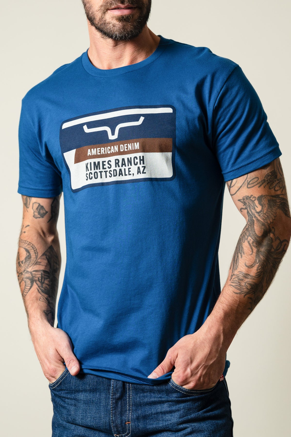 Kimes Ranch Feed Store Cool Blue shirt with graphic print reading AMERICAN DENIM and KIMES RANCH SCOTTSDALE, AZ; #color_cool blue