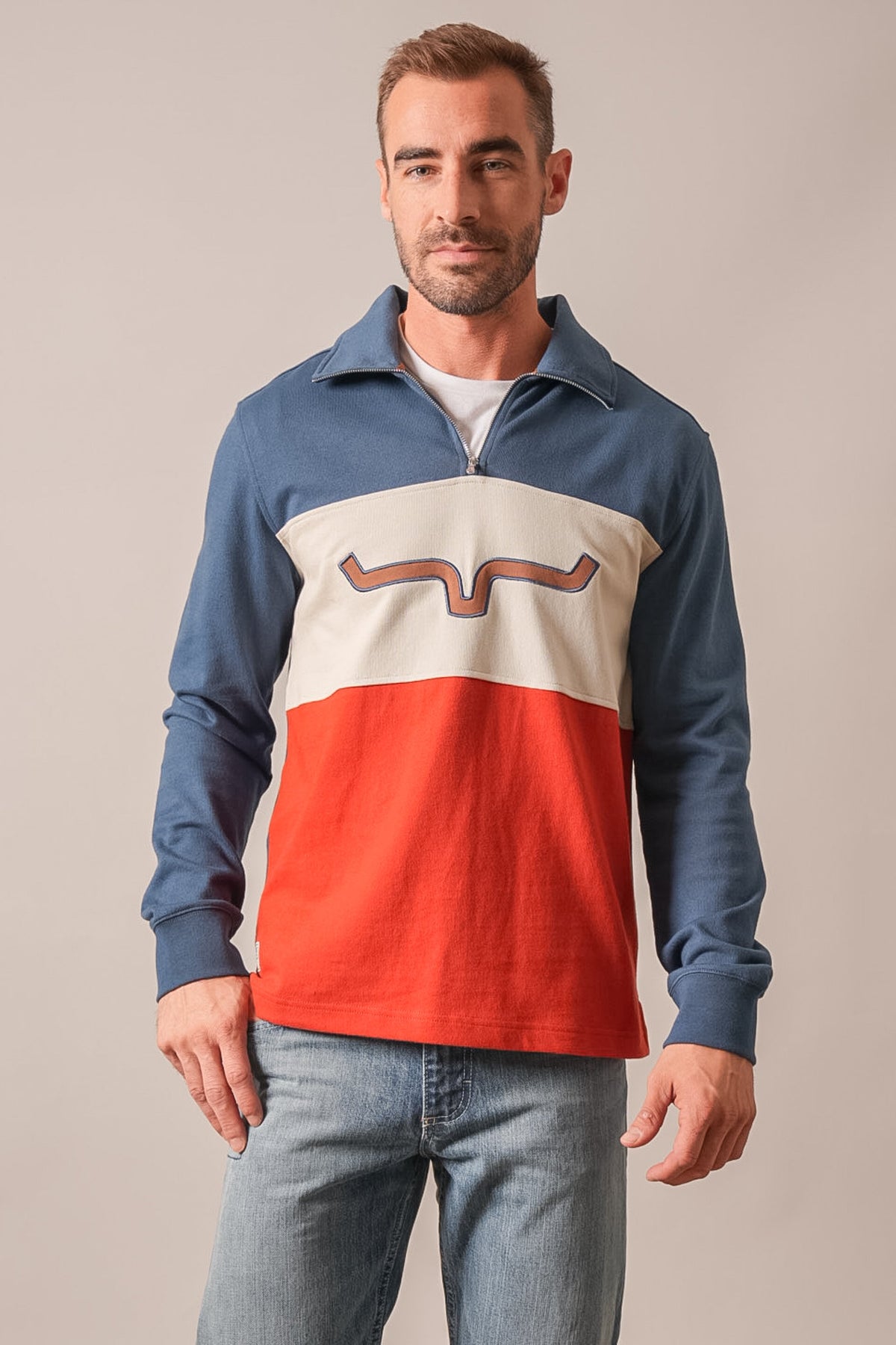 Kimes Ranch Lark polo in Dark Blue, colorblocked with white and orange on the front and a graphic print on the chest
