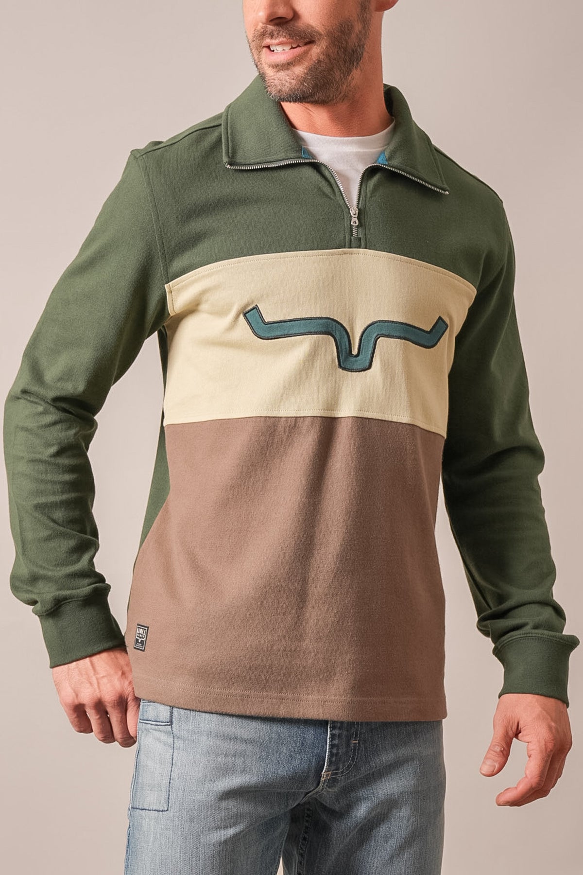 Kimes Ranch Lark polo, long sleeve quarter zip colorblock forest green, tan, cream chest panel with blue wavy logo