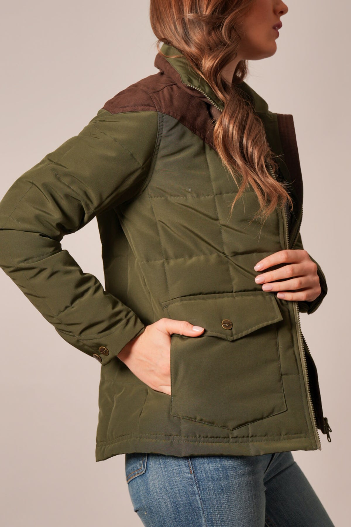 Kimes Ranch Lenora jacket in Dark Olive, side view showing quilted body, contrasting brown shoulders, and flap pocket