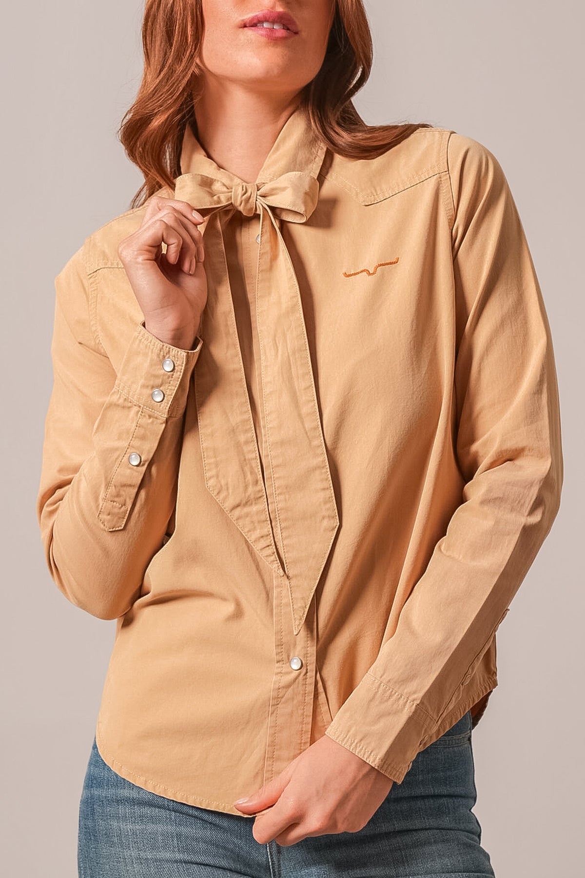 Kimes Ranch Lolo top in Sand with long sleeves, collar, front button placket, and Kimes Ranch logo on left chest