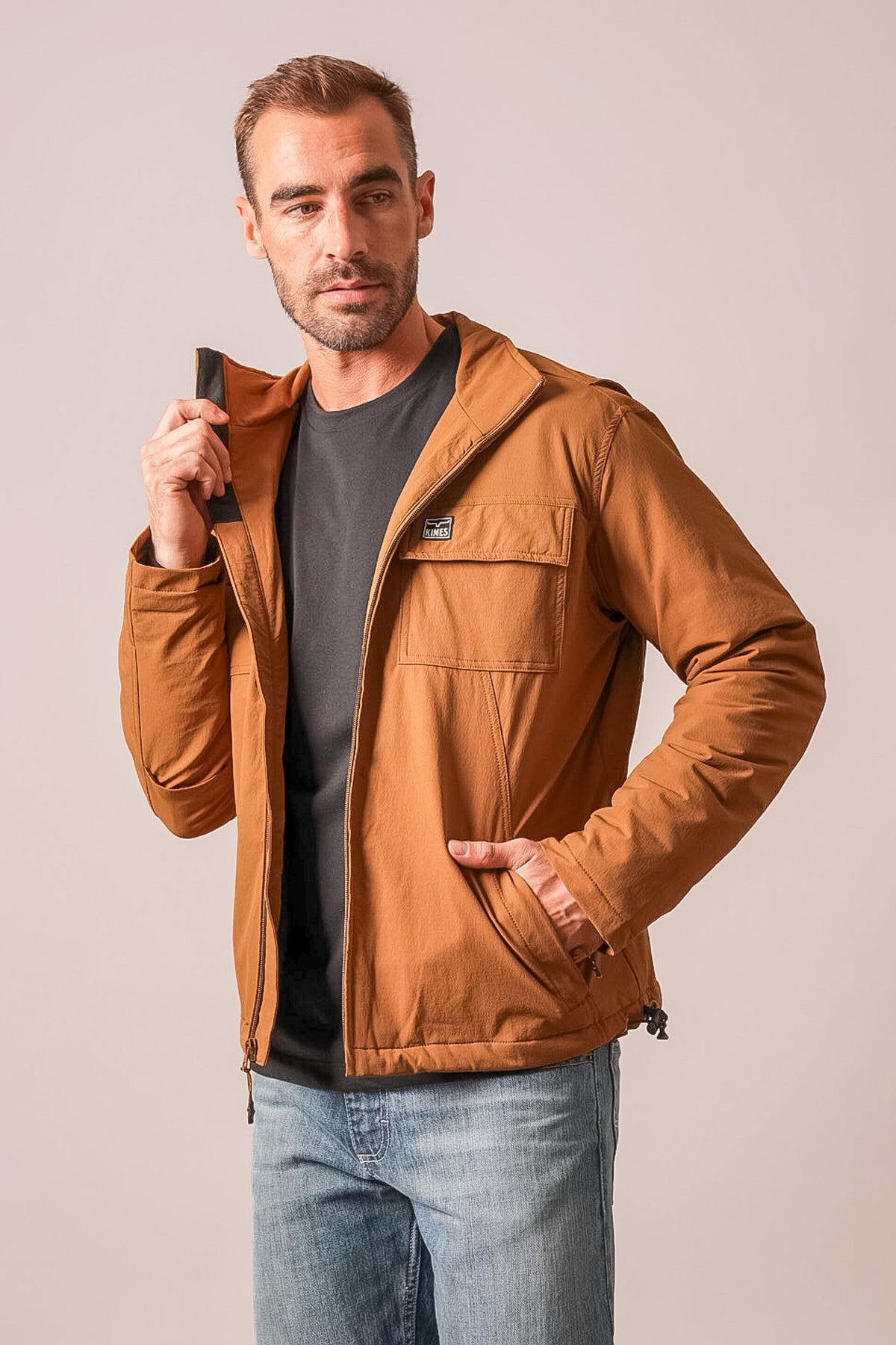 Kimes Ranch Mayfair jacket in Brown with long sleeves, zip front, chest and side pockets, and a Kimes Ranch logo