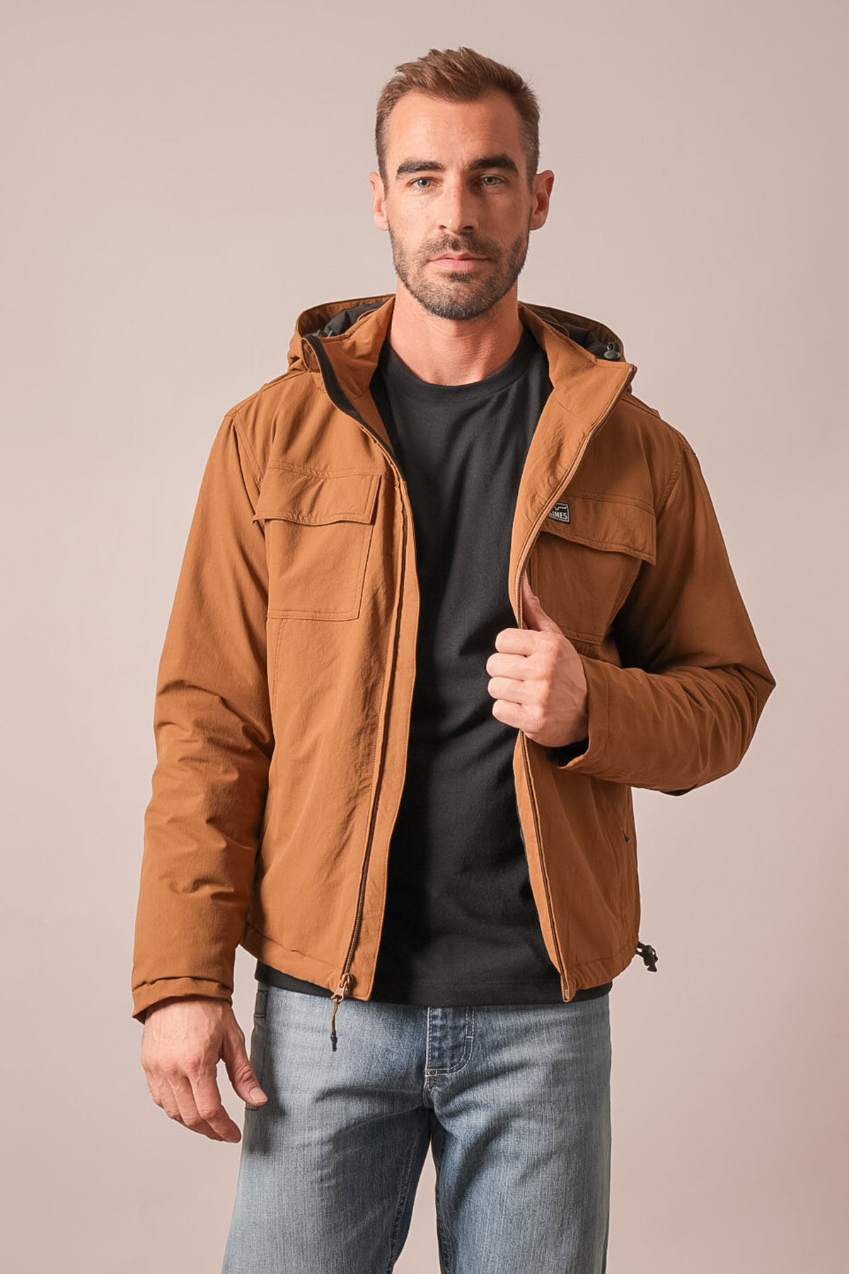 Kimes Ranch Mayfair jacket in brown with hood, front zip, flap pockets, and logo patch on left chest