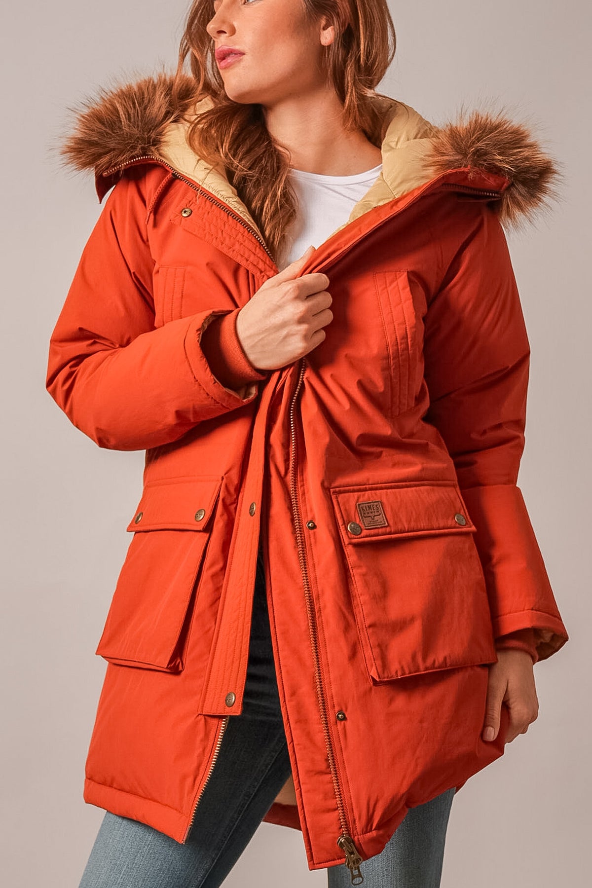 Kimes Ranch Montana jacket in Burnt Red with fur-trimmed hood and logo patch on chest pocket
