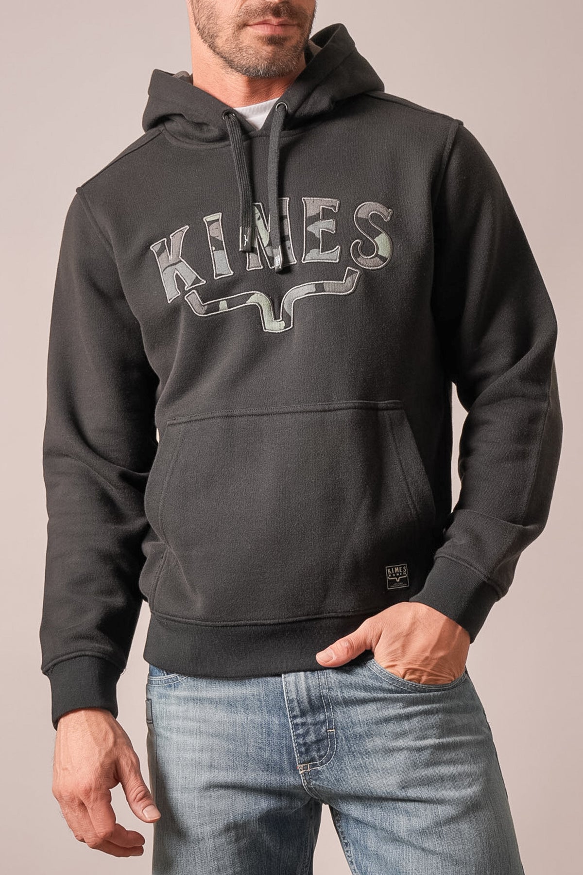 Kimes Ranch Riddle black hoodie with a camouflage Kimes Ranch logo graphic and front kangaroo pocket