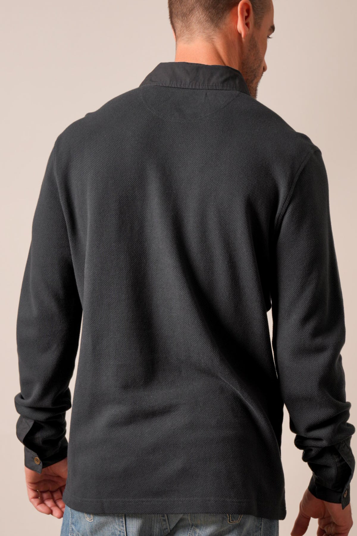 Kimes Ranch Rockaway black polo with long sleeves, spread collar, button cuffs, and back yoke