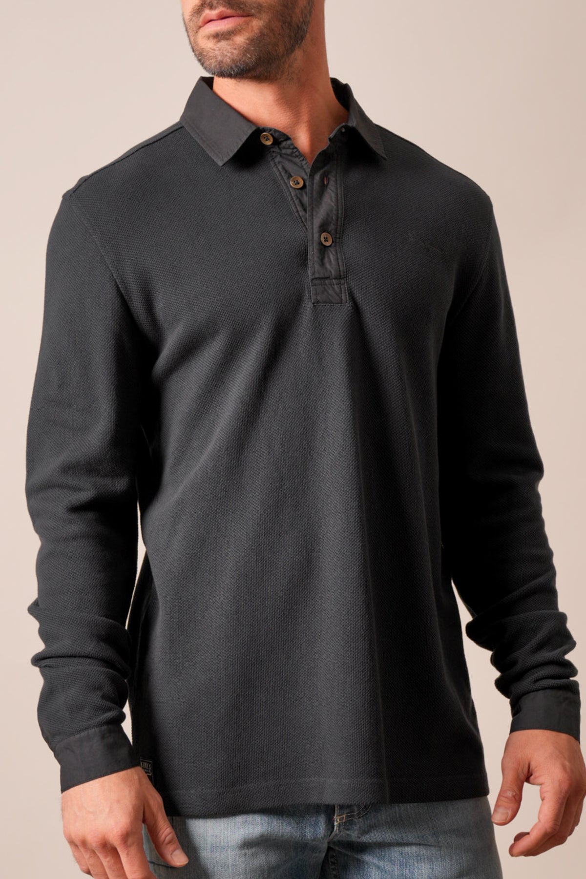 Kimes Ranch Rockaway men's long sleeve polo shirt in black with a textured weave, pointed collar, and button placket