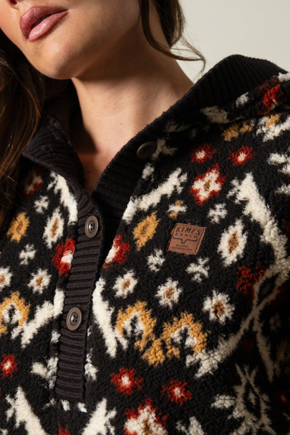 Kimes Ranch Shayla hoodie in Espresso colorway, featuring a floral pattern with a Kimes Ranch logo patch on the chest