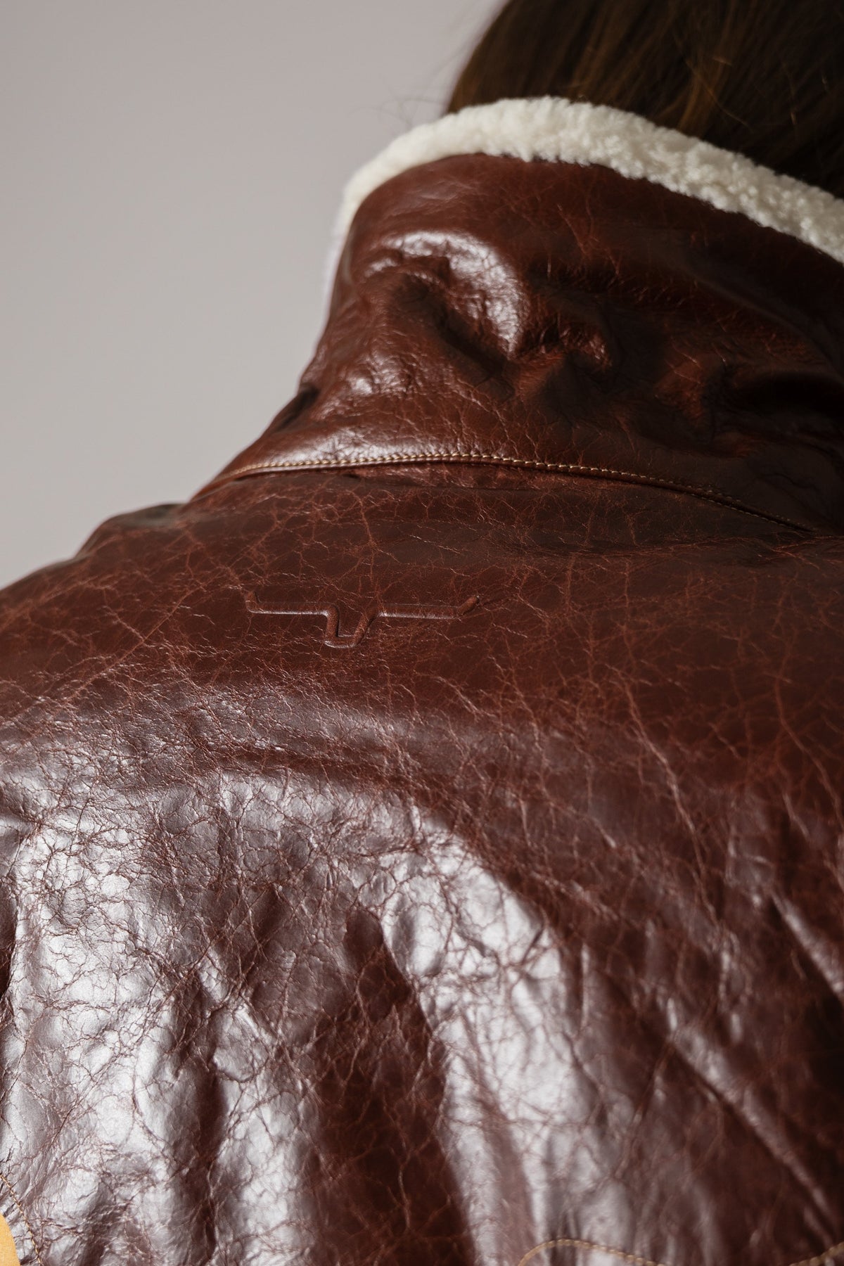 Kimes Ranch Sierra Jacket in Natural with visible distressed leather texture and Kimes Ranch logo on upper back