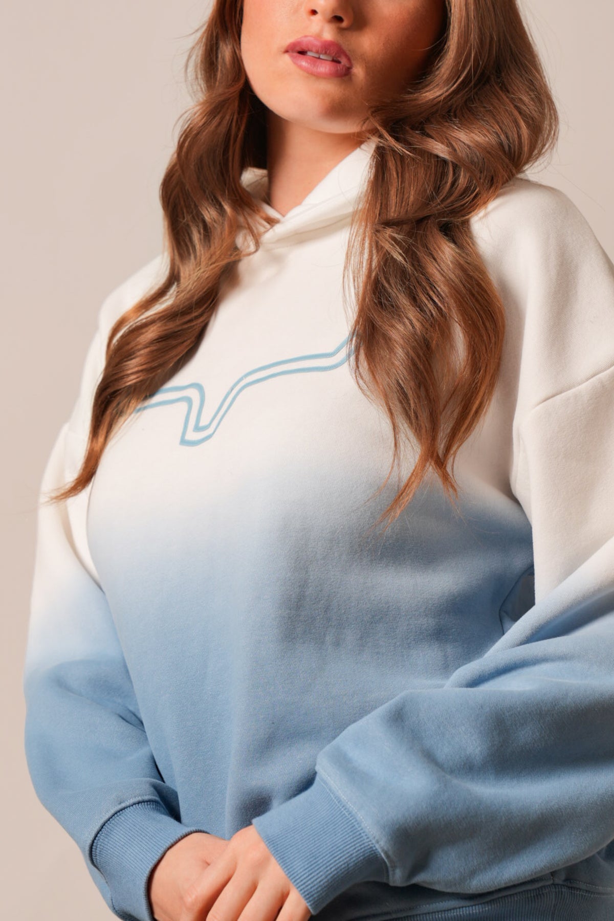 Kimes Ranch Sloane hoodie, chalk colorway, features an ombre blue gradient and a wavy blue outline graphic across the chest