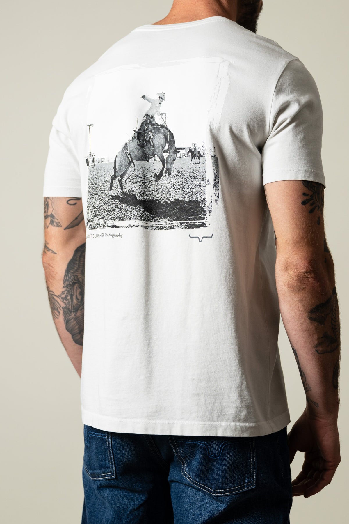 Kimes Ranch SS Bronc Ride shirt in natural with vintage bronc ride photo graphic on back; #color_natural