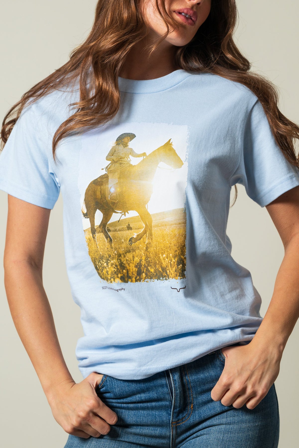 Kimes Ranch SS Riding Sunshine t-shirt, powder blue, with short sleeves, featuring a graphic print of a rider on horseback; #color_powder blue