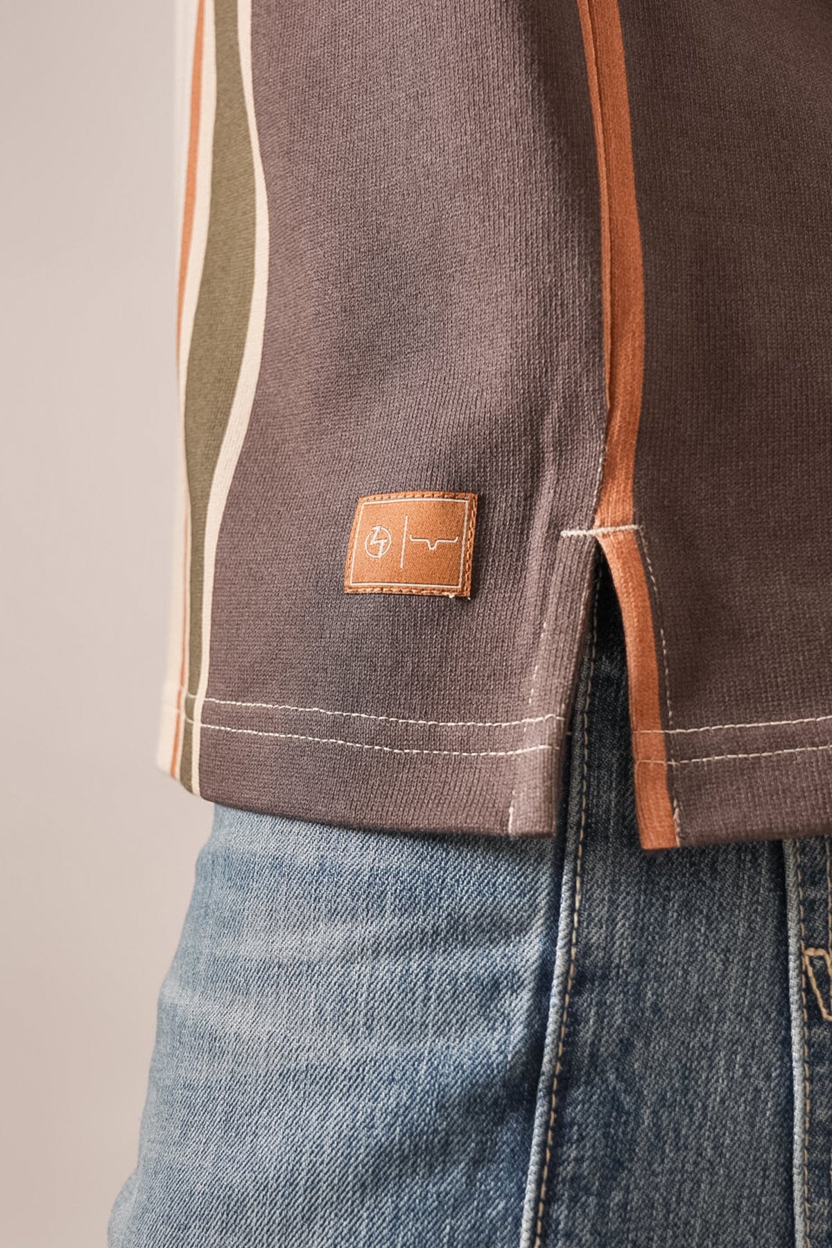 Kimes Ranch ZT Wyatt polo shirt in Espresso, featuring a leather patch detail near the hem