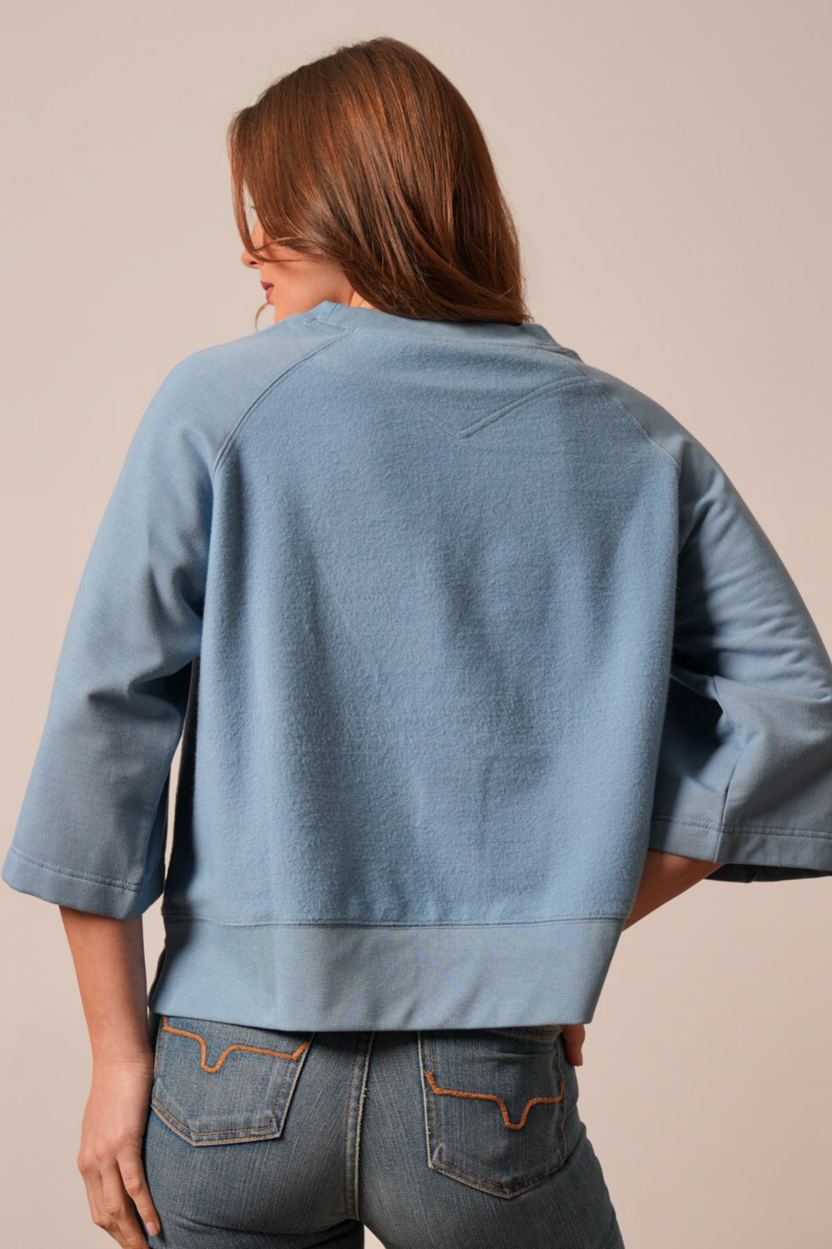 Kimes Ranch Addy sweatshirt in Faded Denim, back view showing raglan sleeves and ribbed hem