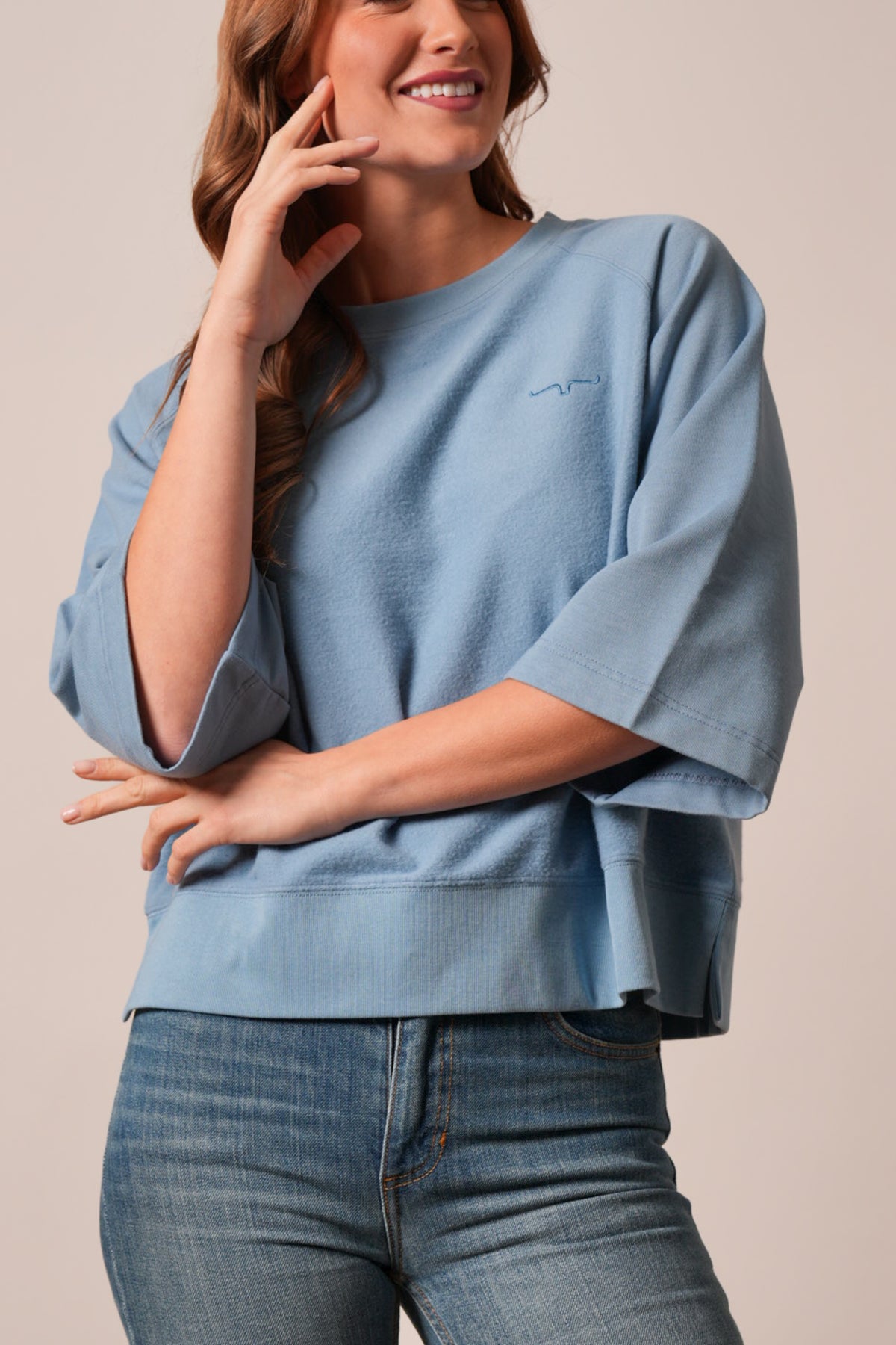 Kimes Ranch Addy sweatshirt in Faded Denim, featuring a crew neck, drop sleeves, side slits, and embroidered Kimes Ranch logo