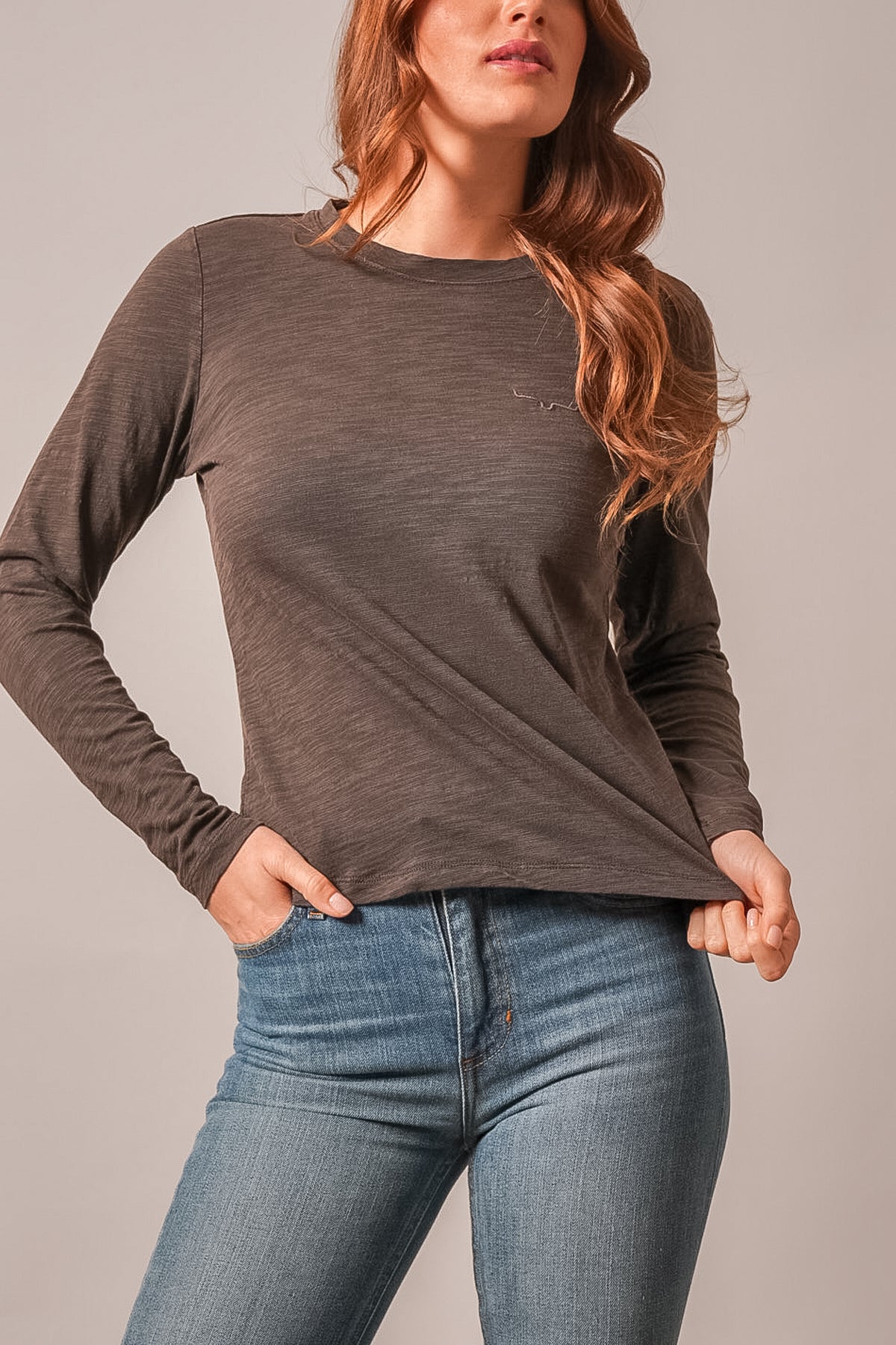 Kimes Ranch Ainsley top in espresso, a long-sleeve tee featuring a Kimes Ranch logo at the chest