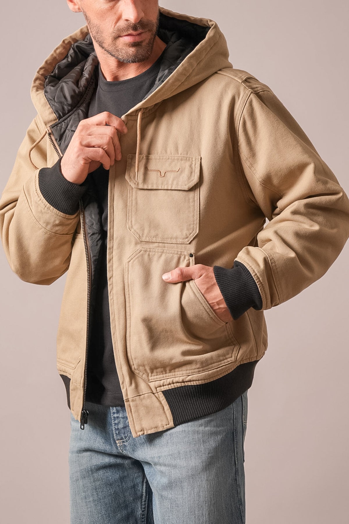 Kimes Ranch Bennett taupe hooded jacket with quilted black interior, Kimes Ranch logo on chest pocket, and zip closure