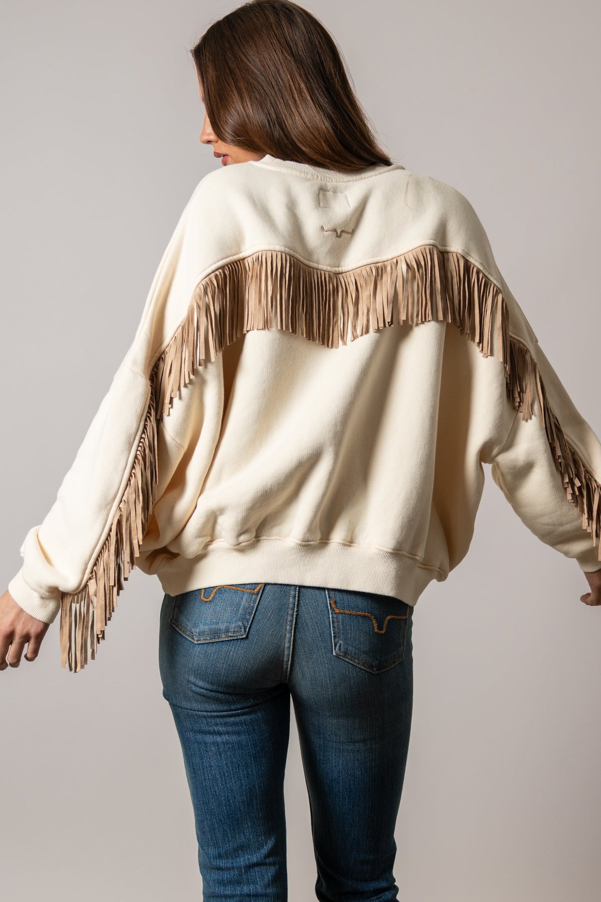 Kimes Ranch Bobby sweatshirt in Natural with long sleeves, tan fringes, and a Kimes Ranch logo on the back