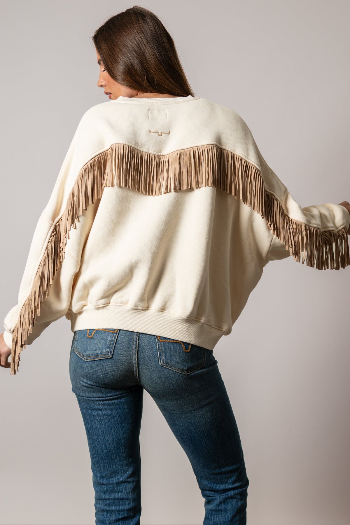 Kimes Ranch Bobby sweatshirt, natural crewneck with long sleeves, tan fringe across yoke and arms, logo at back