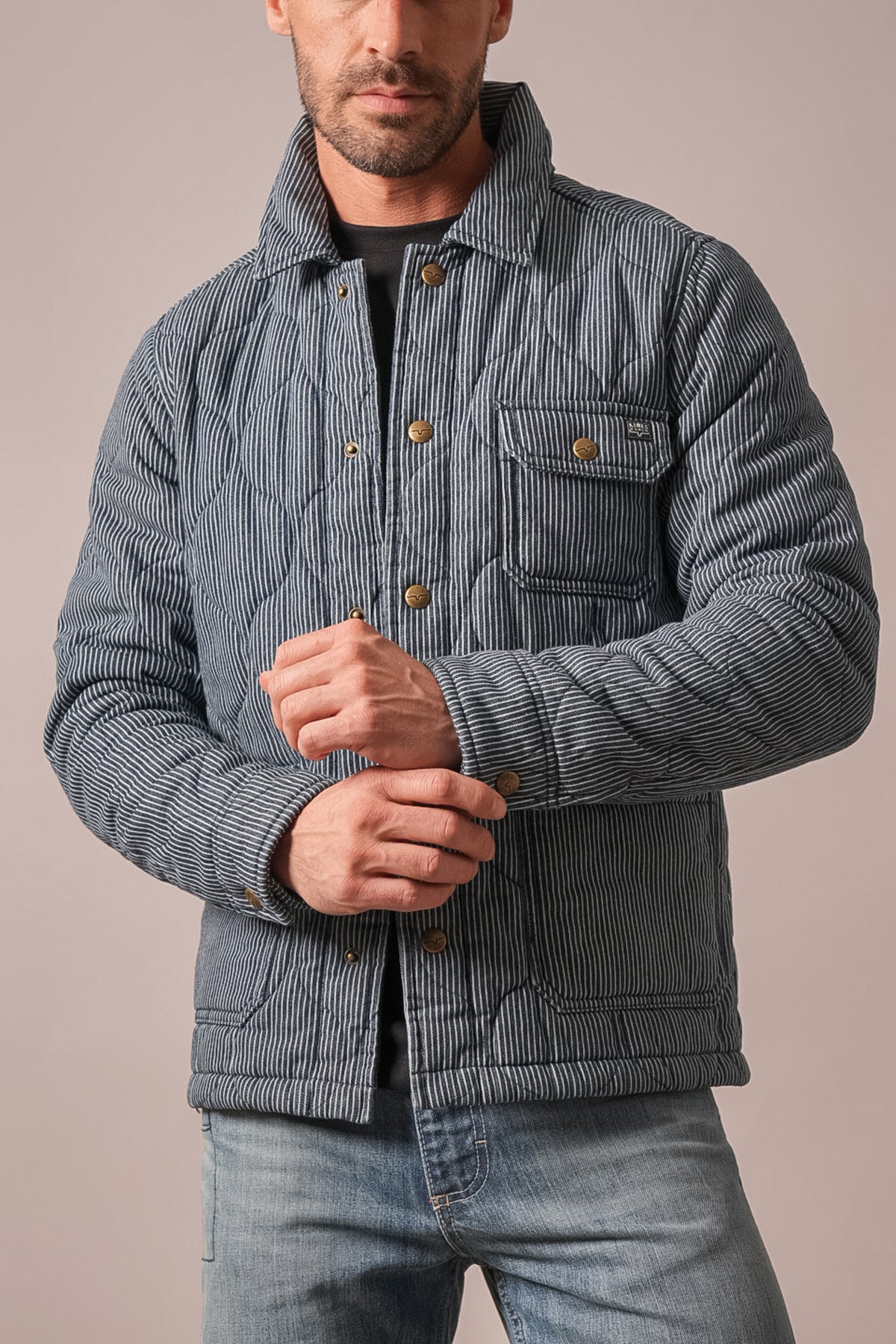 Kimes Ranch Buster indigo quilted jacket with long sleeves, two chest flap pockets, and brass snap buttons