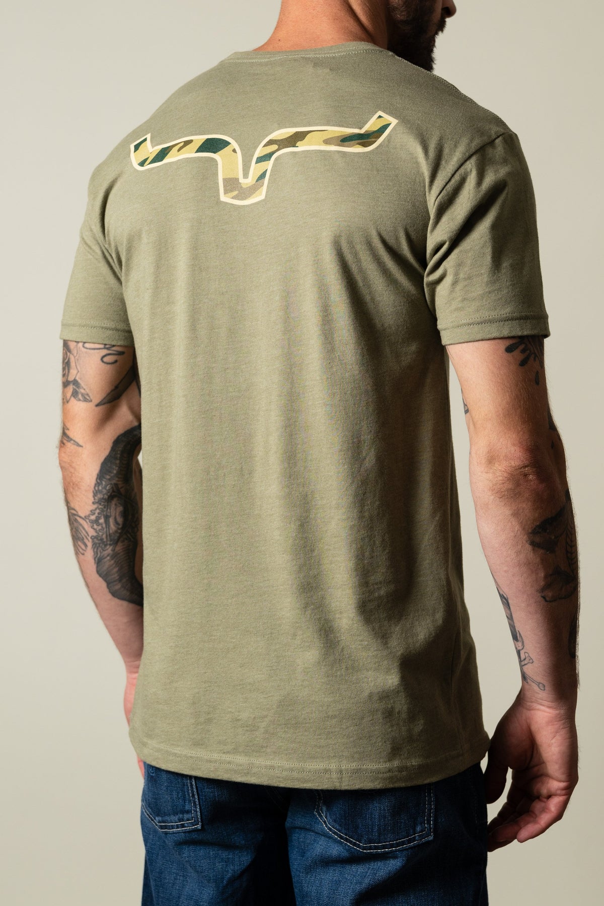 Kimes Ranch Camo Back light olive t-shirt with camo print Kimes Ranch logo on the back; #color_light olive