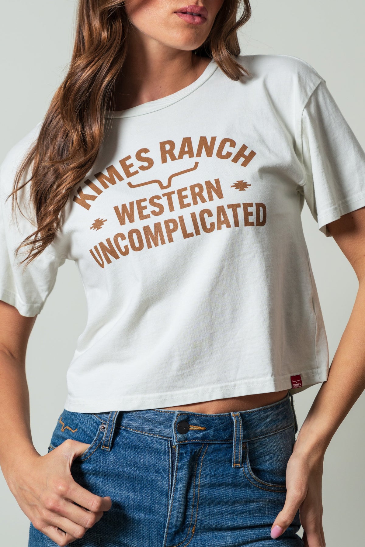 Kimes Ranch Cavell Natural crewneck shirt featuring arched 'KIMES RANCH' and stacked 'WESTERN UNCOMPLICATED' graphics; #color_natural