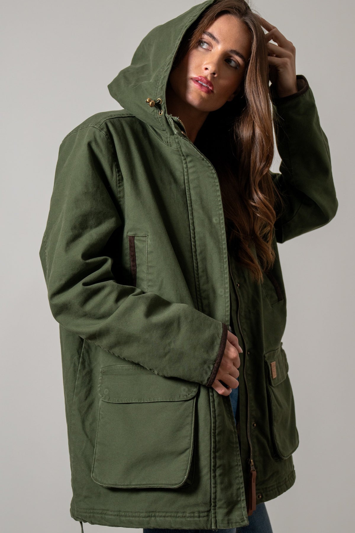 Kimes Ranch Emery jacket in Moss with hood, brass toggles, zippered chest pocket, flap pockets, and leather trim