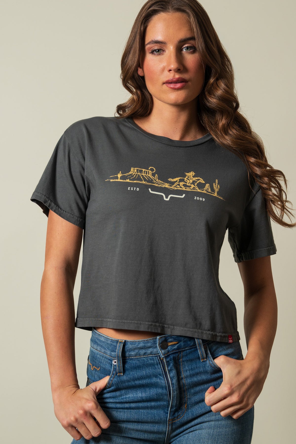 Kimes Ranch Go West short sleeve crop tee in Pepper with gold graphic showing cowboy, landscape, and ESTD 2009; #color_pepper