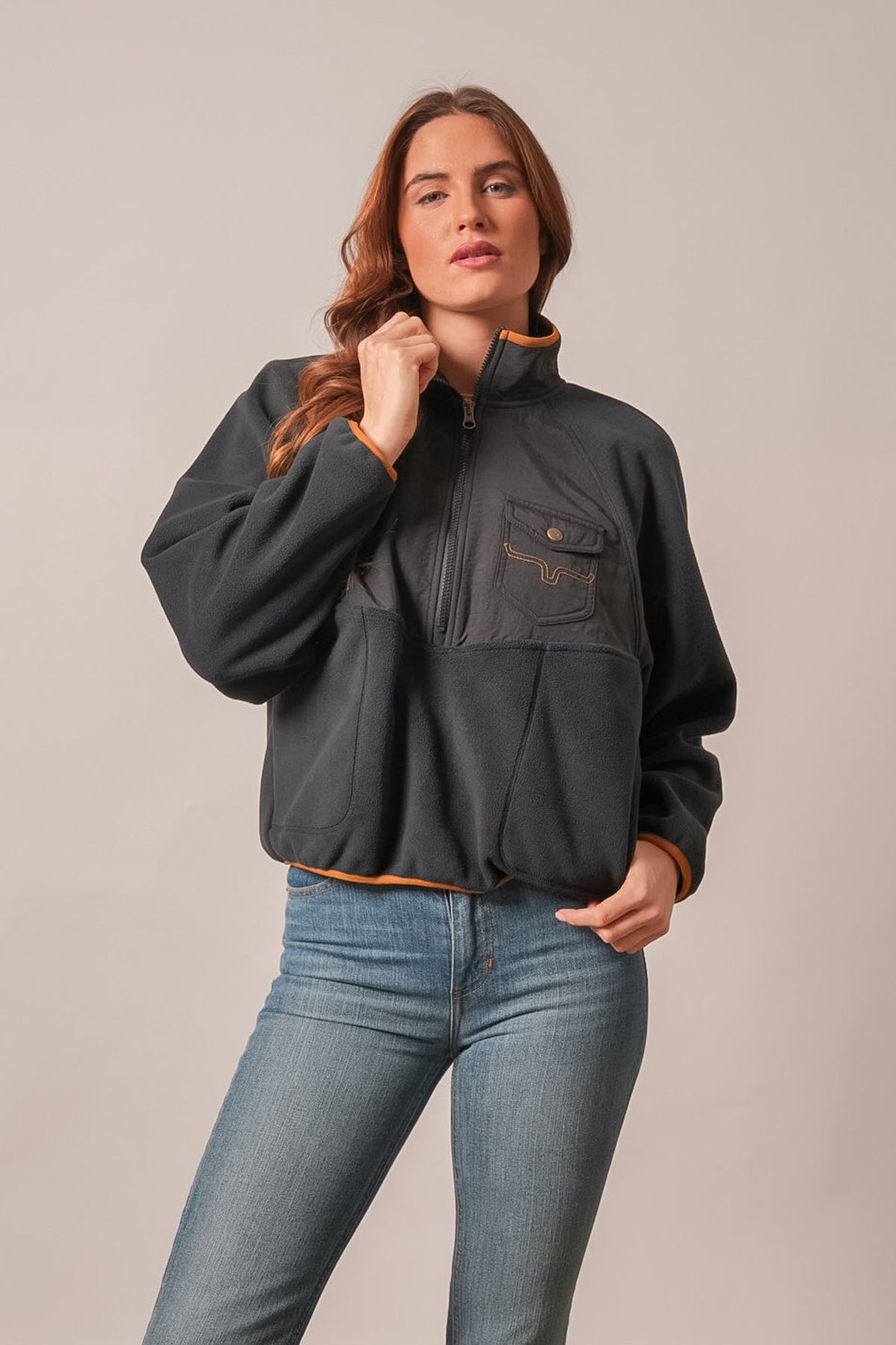 Kimes Ranch Indie black sweatshirt with orange collar trim, long sleeves, front zip pocket with logo, and kangaroo pocket