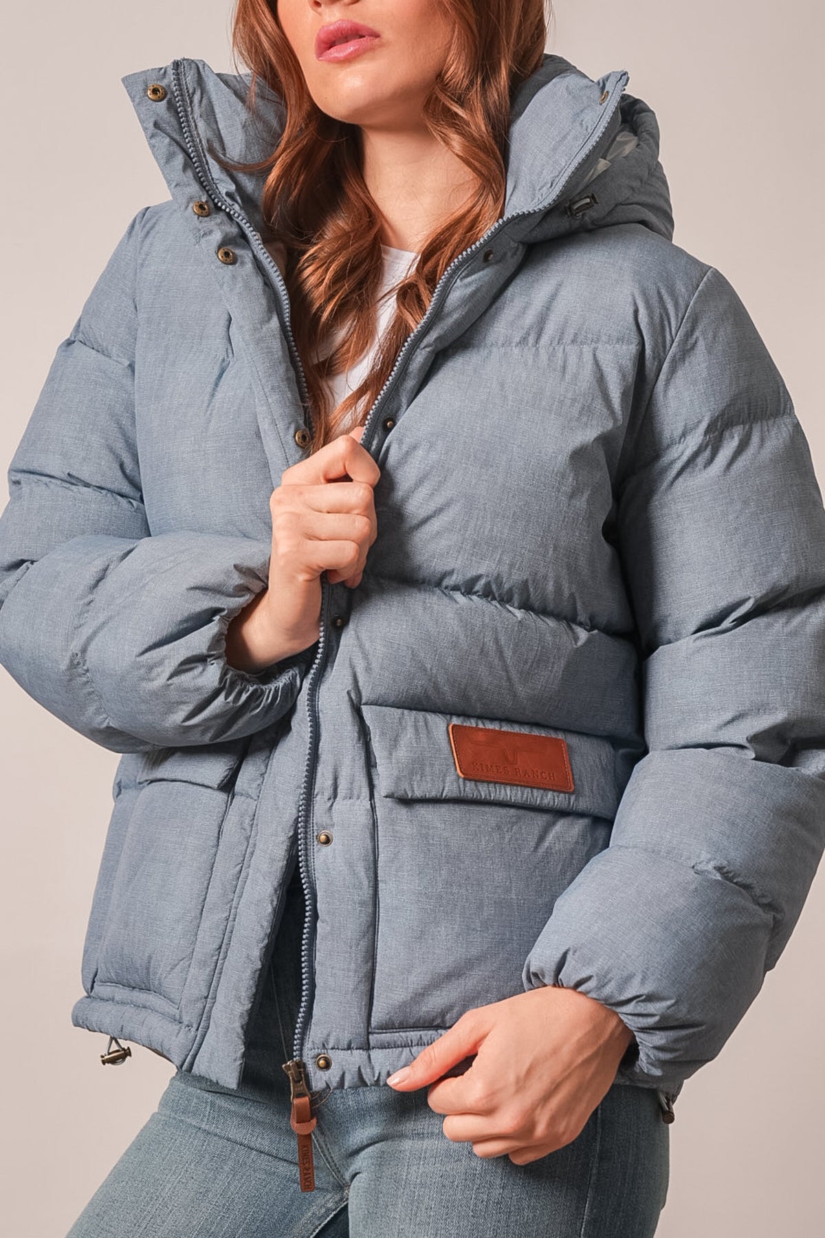 Kimes Ranch Letty jacket in Faded Denim with quilted hood, snap placket, and Kimes Ranch logo on front pocket