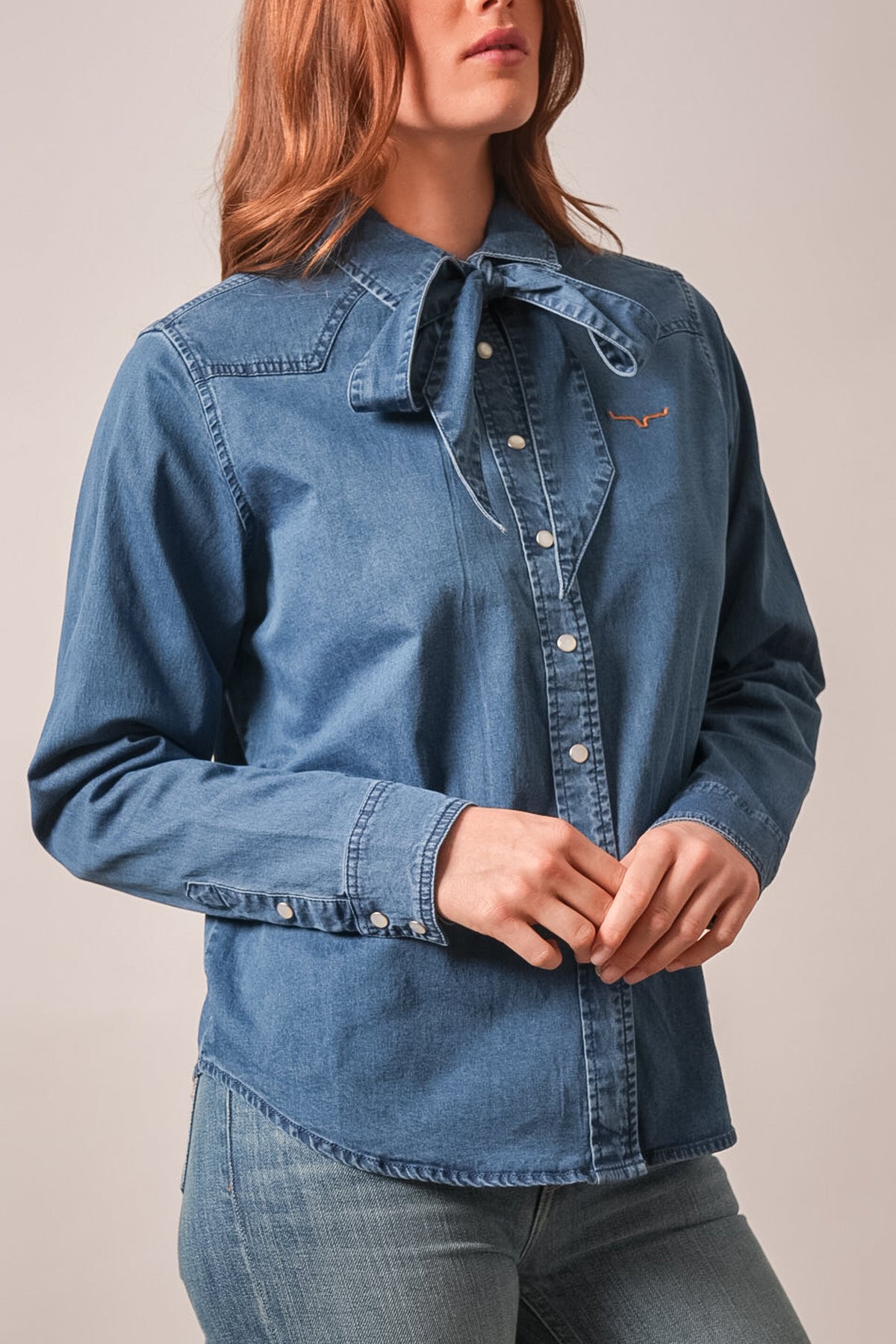 Kimes Ranch Lolo indigo denim top with long sleeves, snap closures, and Kimes Ranch logo