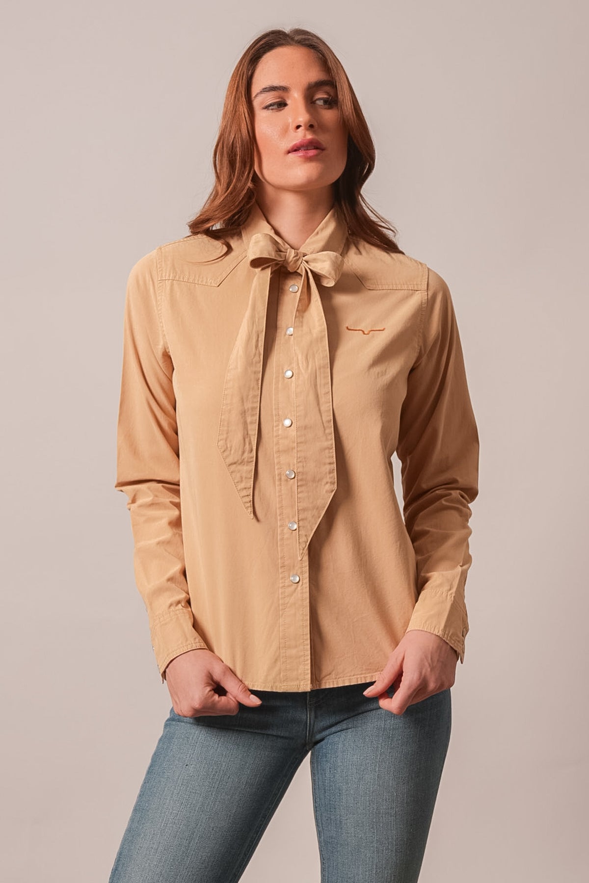 Kimes Ranch Lolo long sleeve button top in Sand with front tie, chest yoke, and Kimes Ranch logo on left chest