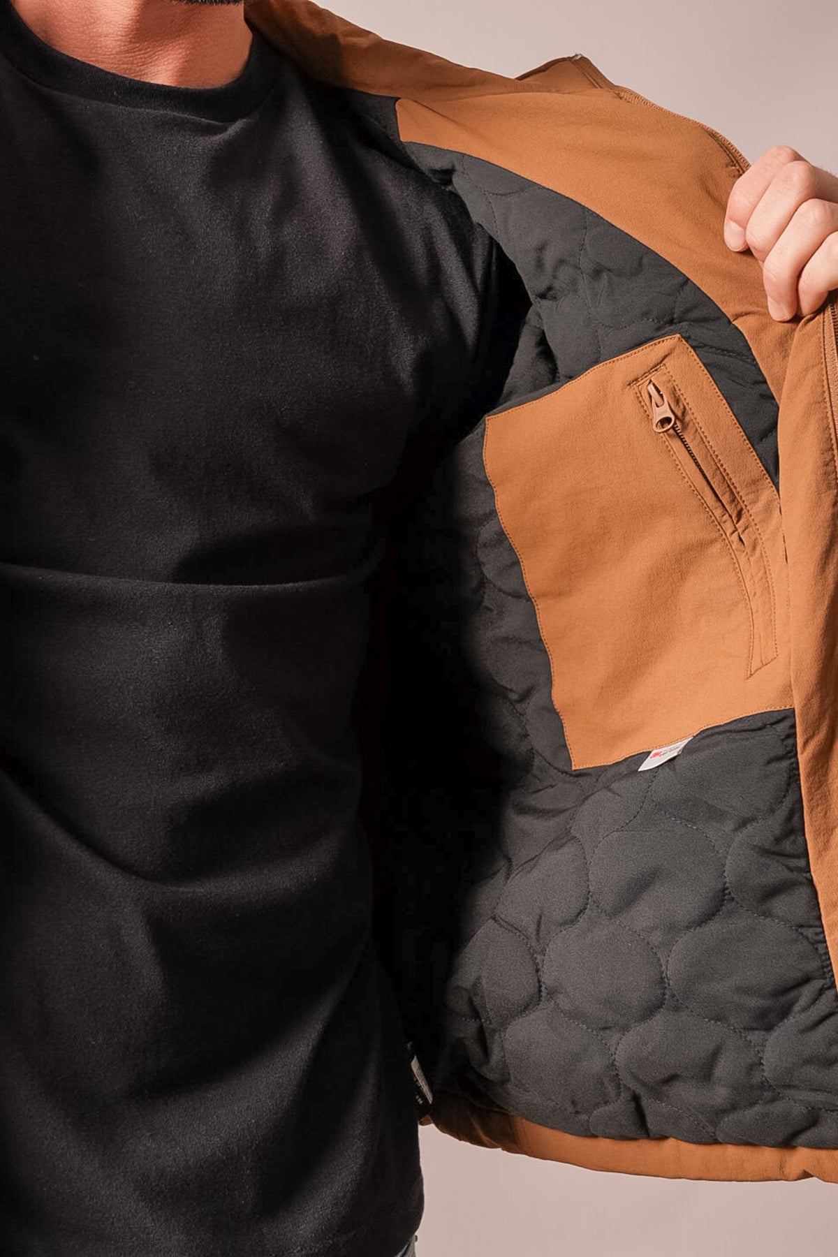 Kimes Ranch Mayfair brown jacket detail showing black quilted lining and tan zippered interior pocket