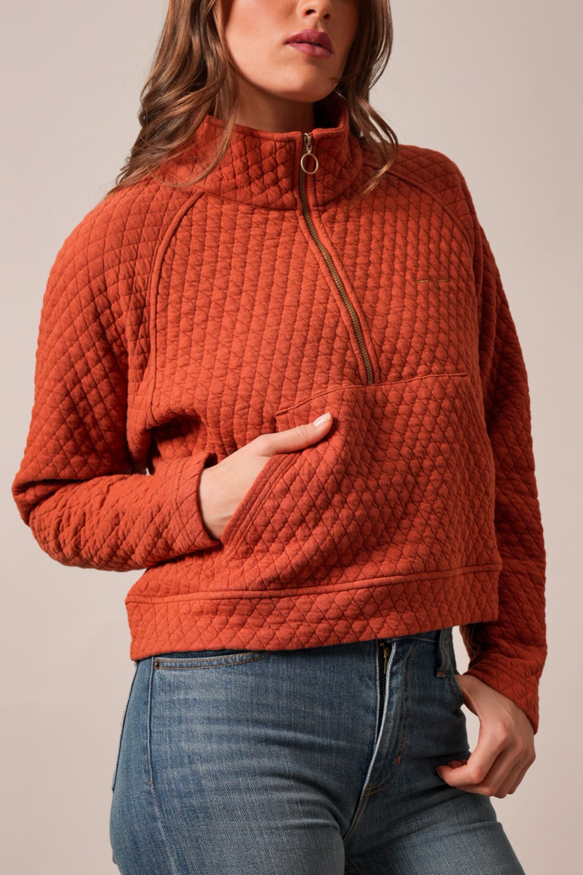 Kimes Ranch Rita sweatshirt in Burnt Red with diamond quilting, raglan sleeves, zip-neck, and patch pockets