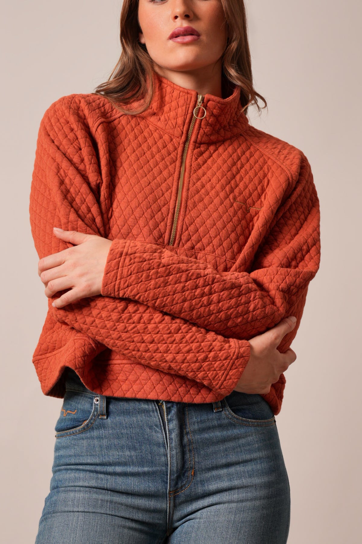 Kimes Ranch Rita sweatshirt in Burnt Red with diamond quilting, half-zip collar, and logo on left chest