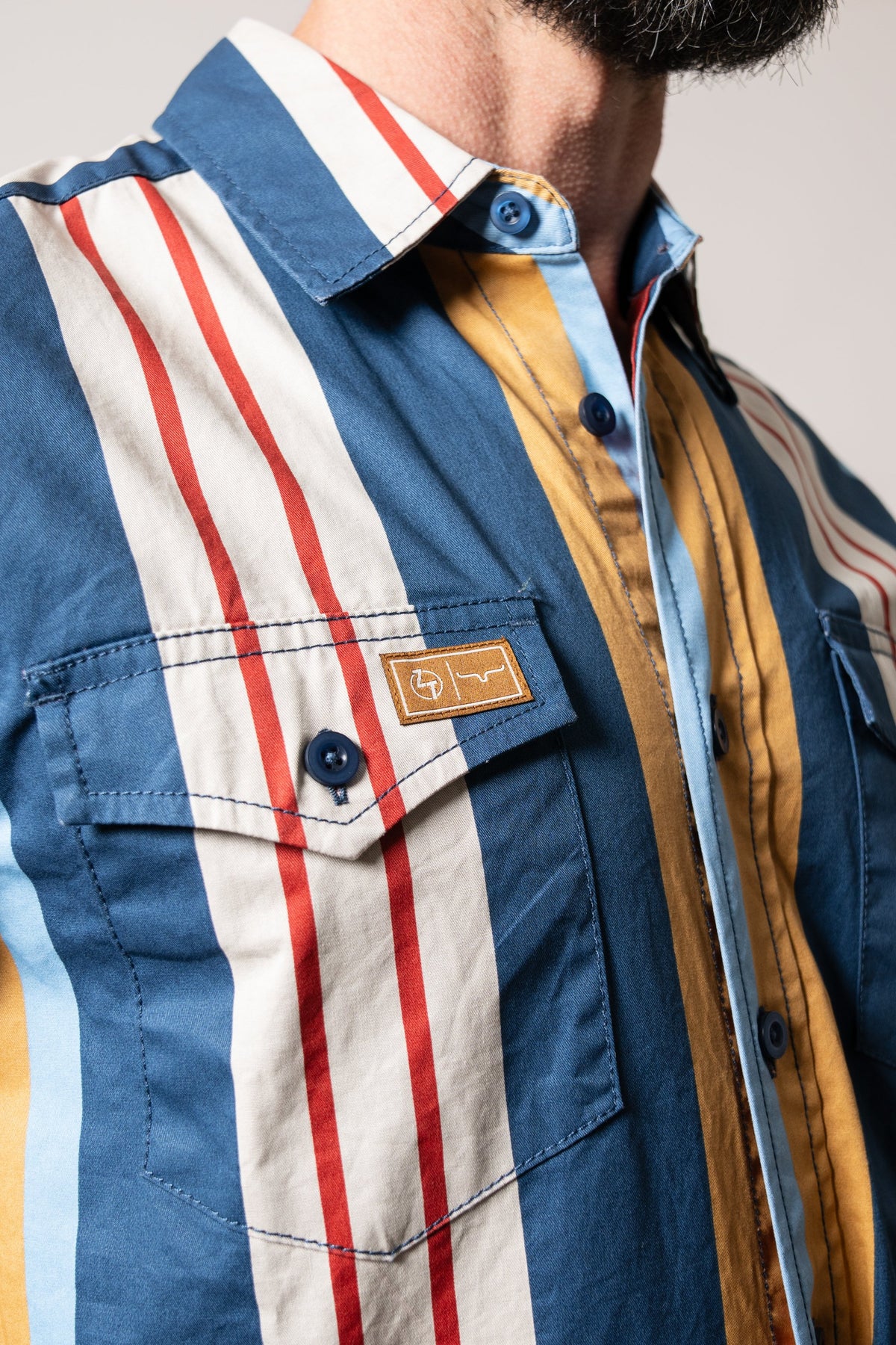 Kimes Ranch ZT Noxx dark blue long-sleeve dress shirt featuring vertical stripes in dark blue, rust red, white, and yellow